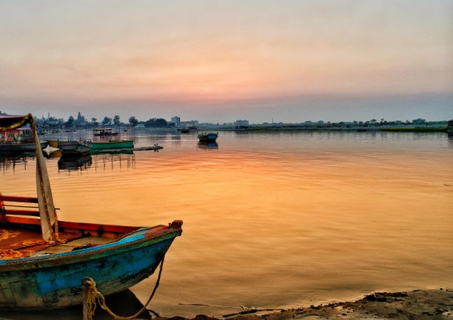 Dinghies on water during sunset