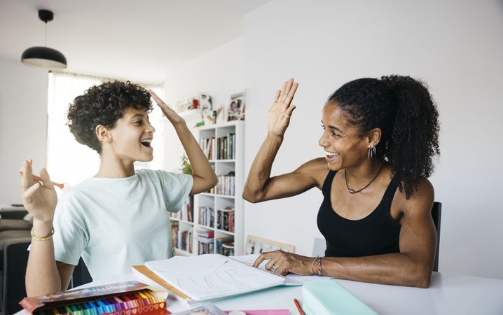 Girl doing her homework with mother