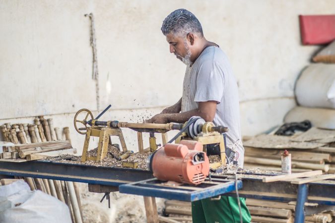 Man using woodworking machine at workplace