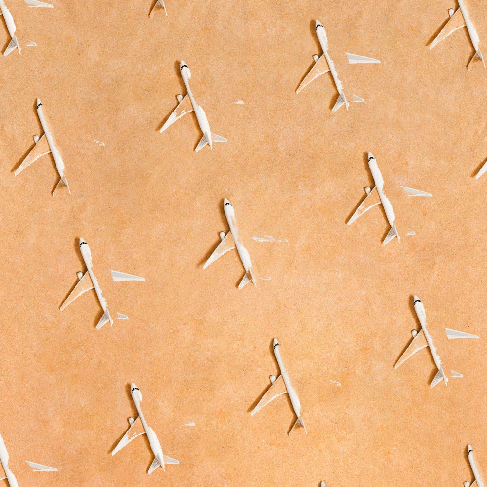 Rows of airplane partially submerged in sand