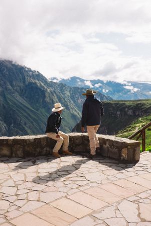 Back of two men in hats enjoying view in Peruvian Andes