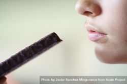 Anonymous teenage girl about to eat cocolate bar 4MGDax