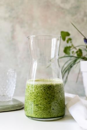 Organic Green smoothie detox drink in a glass bottle