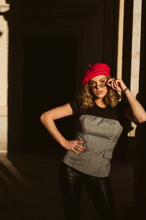 Stylish female standing near building wall