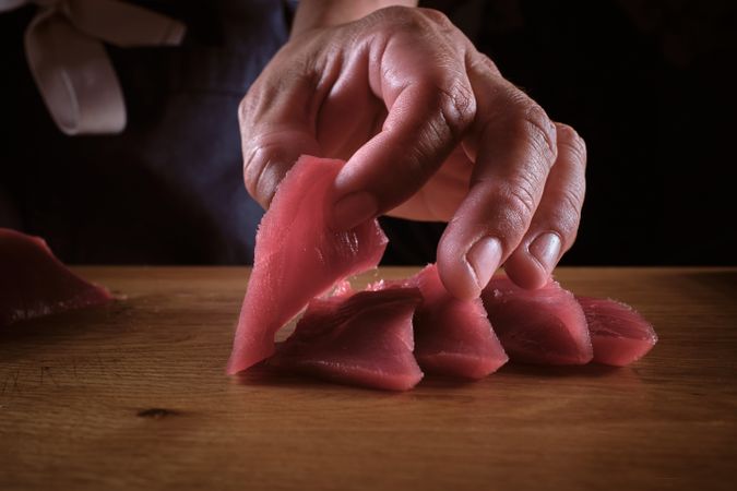 Male hands slicing fresh bluefin tuna loin