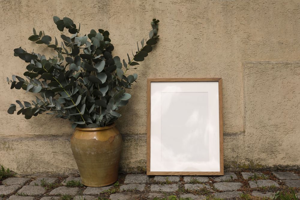 Blank wooden picture frame mockup against old textured wall