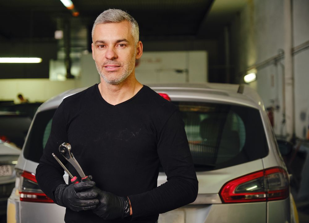 Confident mechanic in garage