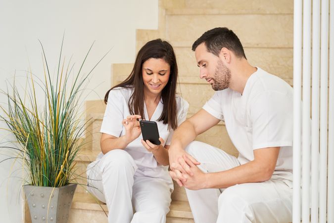 portrait of two physiotherapists looking at the following patien