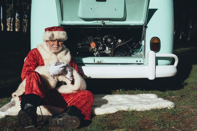 Santa Claus resting by old van