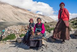 Tibet - August, 29 2014: Tibetan men and women in mountainous region