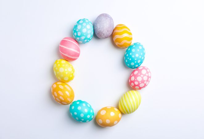 Decorative Easter eggs on neutral background, space for text. Top view