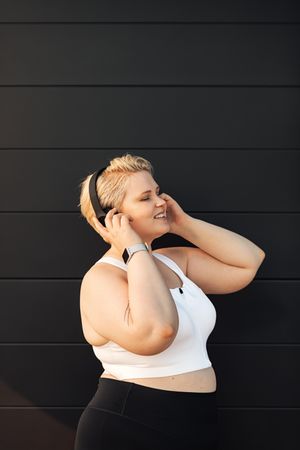 Smiling woman with eyes closed listening to headphones