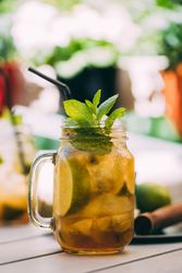 Mojito in mason jar on wooden table