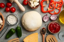 Ingredients for cooking pizza on gray background, top view