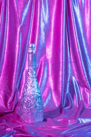 Holographic abstract pastel colors backdrop with Champagne bottle, vertical composition