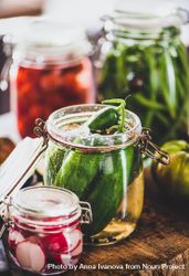 Glass jars of pickled vegetables on kitchen counter 5nQDn0