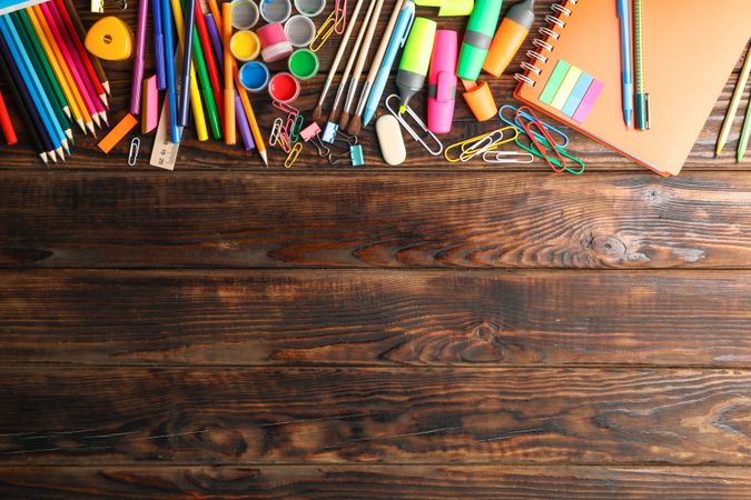 Flat lay composition with school supplies on wooden background, space for text