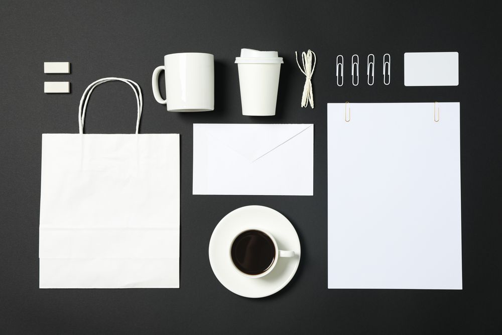 Flat lay composition with blank stationery on dark background, copy space