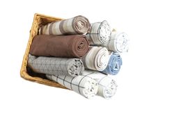 Rolled up fabric napkins in basket isolated on plain background