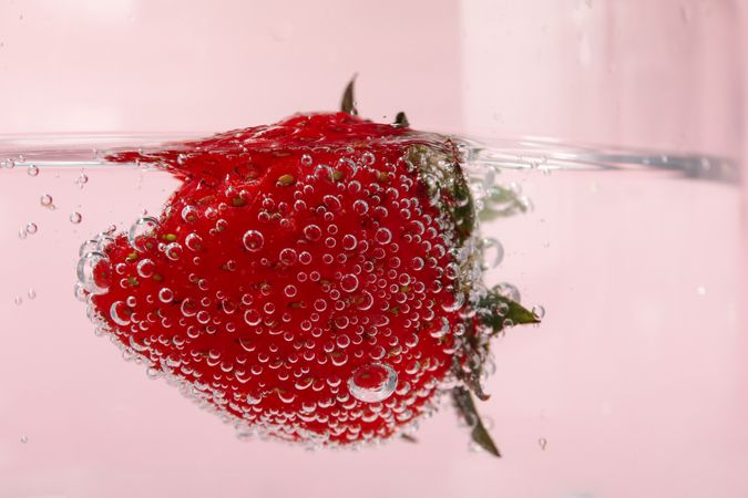 Close up of strawberry floating in water