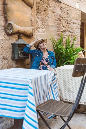 Woman sitting on the terrace of a restaurant