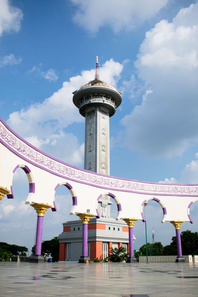 Semarang, Indonesia - April 26 2024. Tower Monument with antenna on top, cloudy blue sky as background