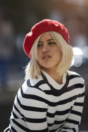 female in red beret outdoors