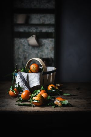Mandarins and basket on table