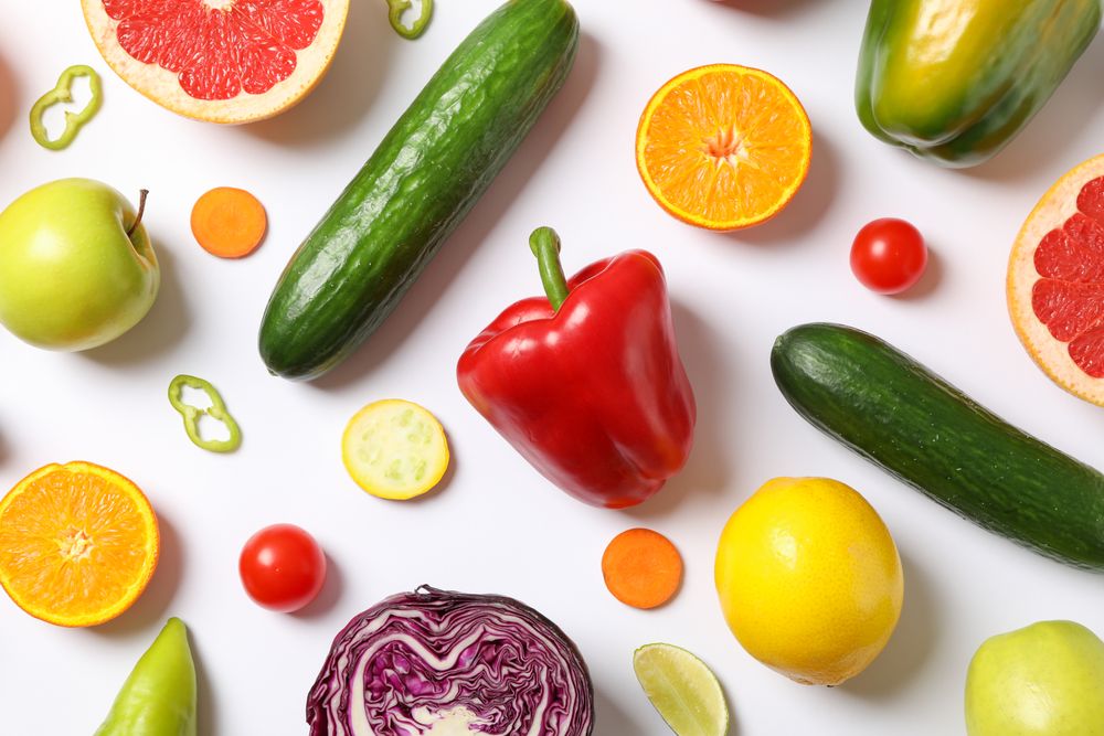 Different vegetables and fruits on plain background, top view
