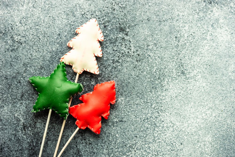 Top view of three felt Christmas decorations on grey counter