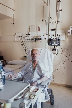 Older man admitted to a hospital room.
