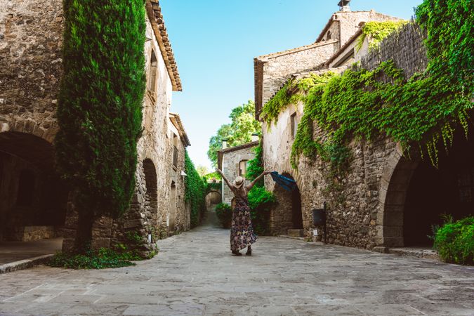Woman walking in a narrow path in a village