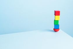 Colorful wooden blocks on light blue background