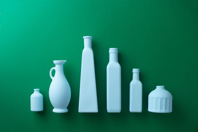Painted glass bottles on green background
