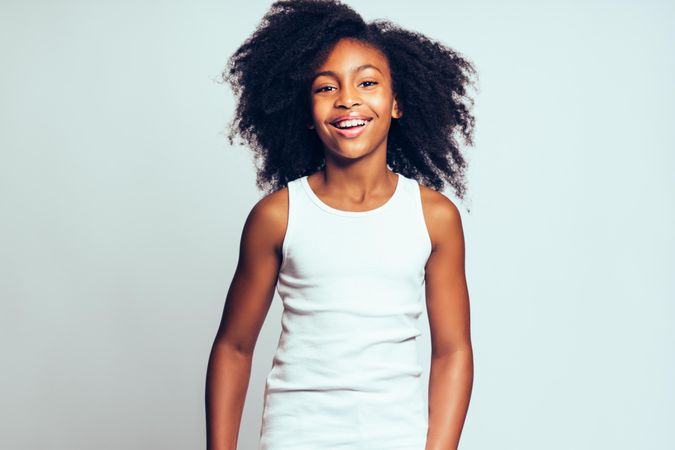 Portrait of confident smiling girl wearing simple vest