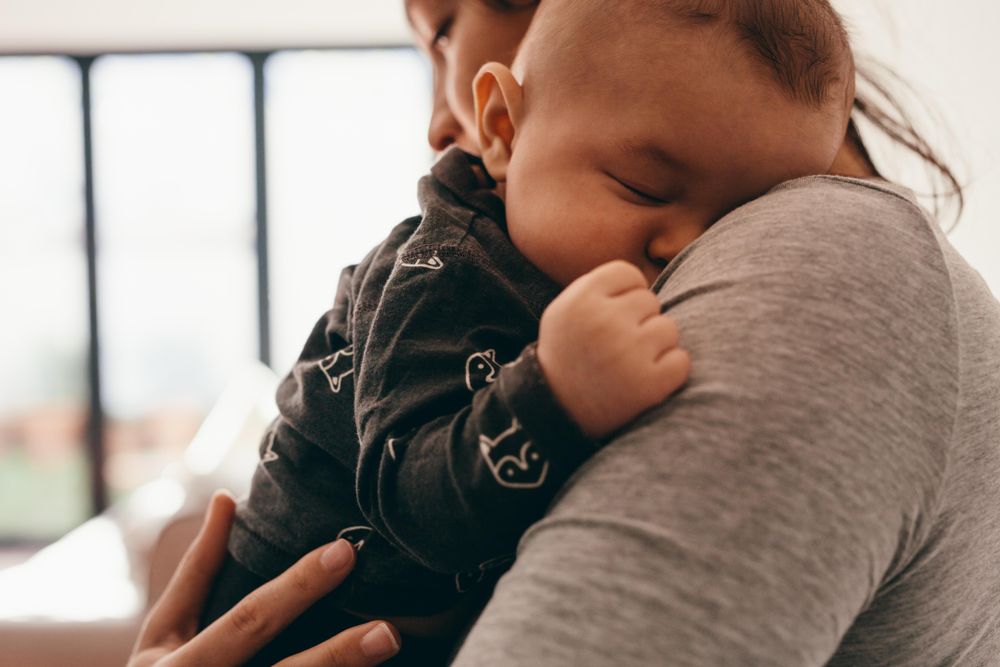 Top View Of A Baby Sleeping In The Lap Of His Mother, 55% OFF