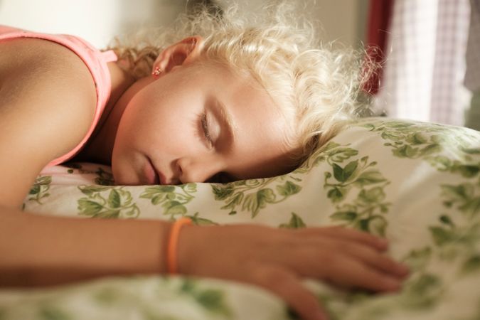 Relaxed girl sleeping in bed