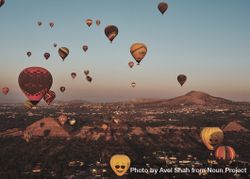 Many hot air balloons in flight over pyramids in Teotihuacan Valley 0JLjl4