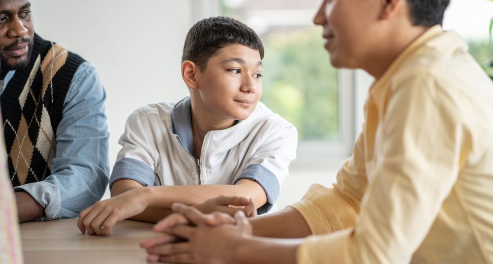 Student looking around from table in classroom
