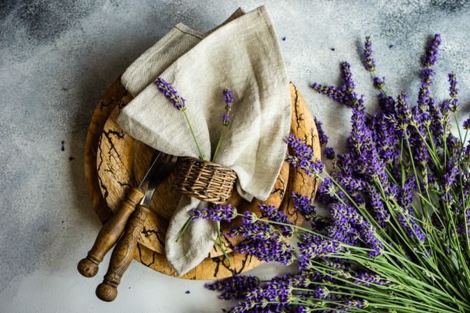 Brown plate table setting with napkin and bunch of lavender