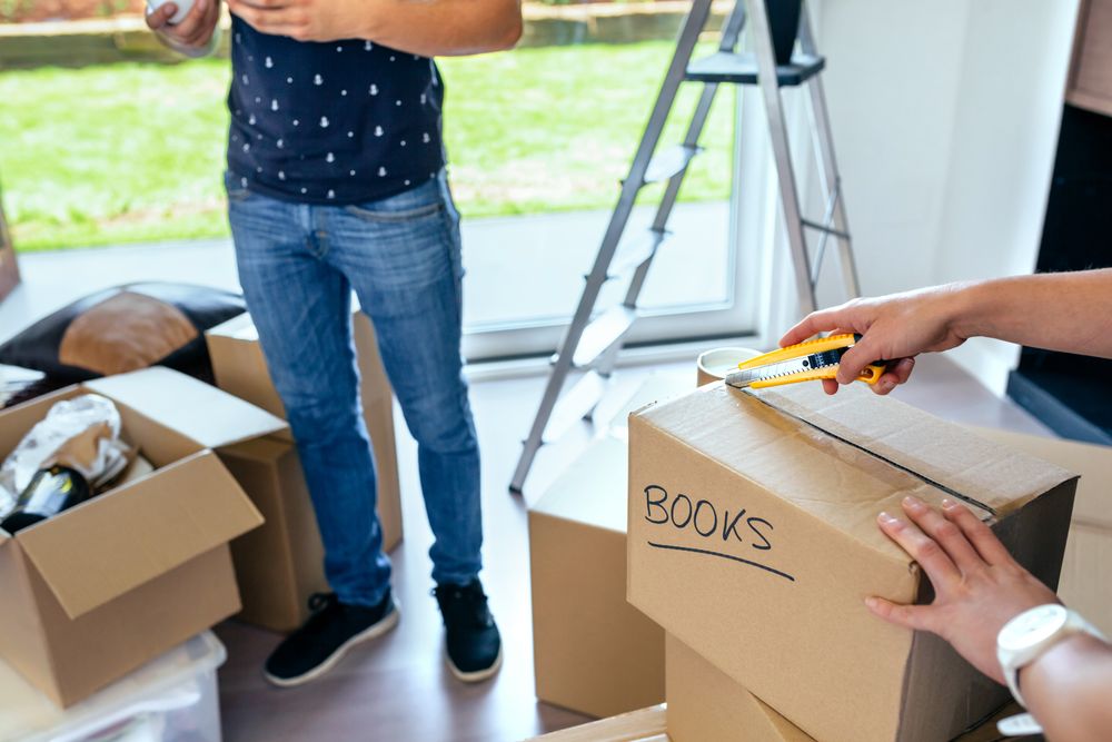 Couple unpacking moving boxes