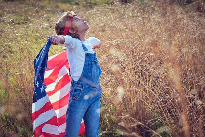 Boy with USA flag in nature