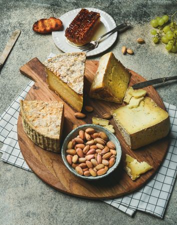 Flat-lay of cheese spread on wood board