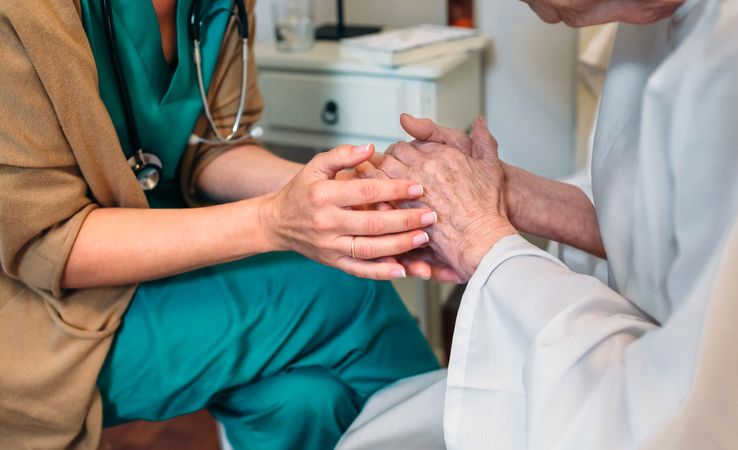 Doctor giving encouragement to mature patient