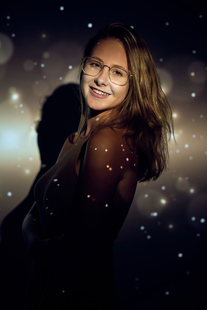 Cheerful young woman under sparks
