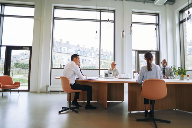 Group of people working at open desks in a modern office