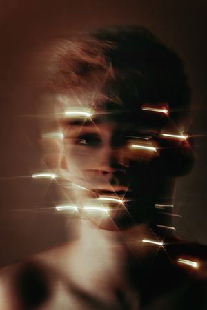 Blurry portrait of blonde young man with string light