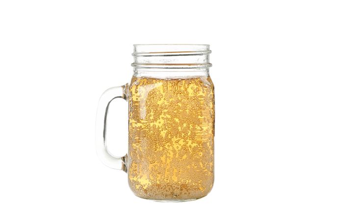 Glass jar with cider isolated on blank background