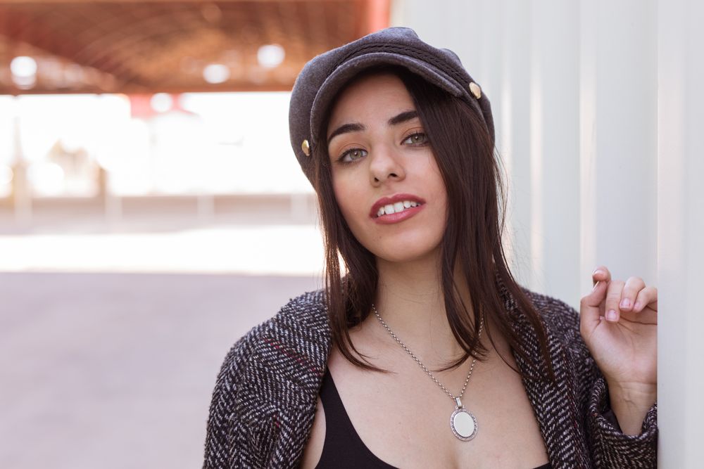 Charming Hispanic woman near wall