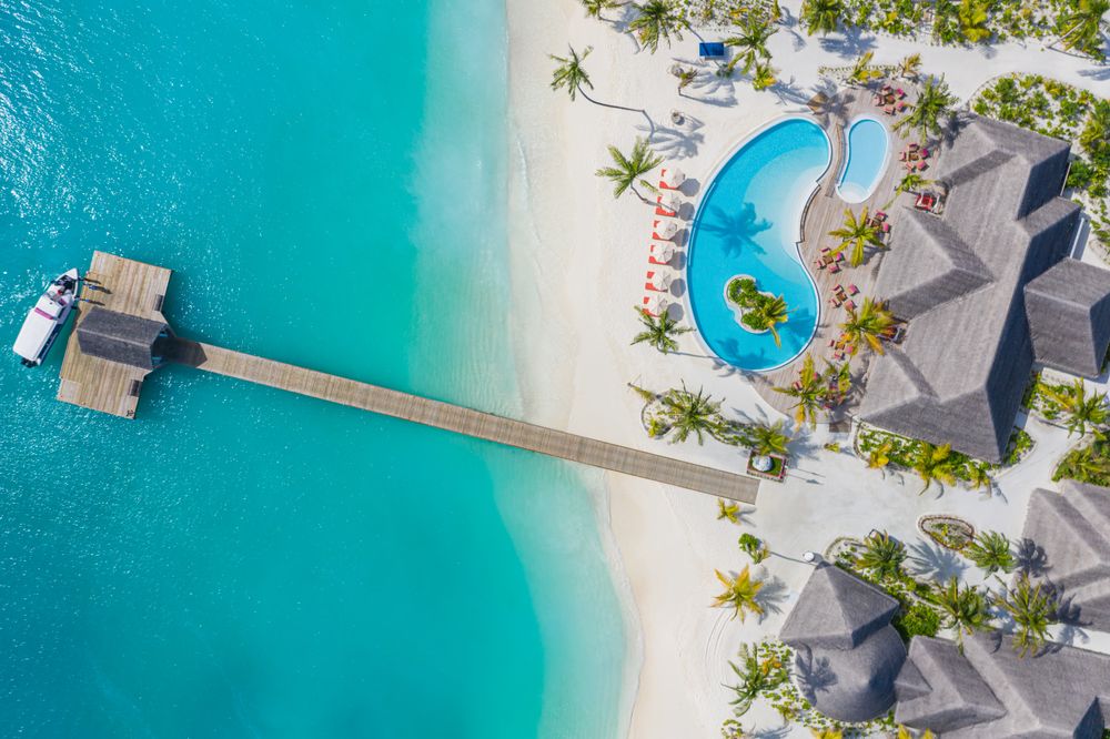 Aerial shot of long pier at a tropical holiday resort